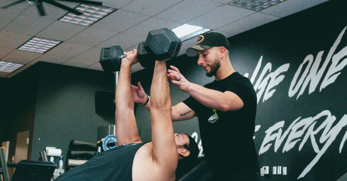 2 Guys Exercise At The Gym